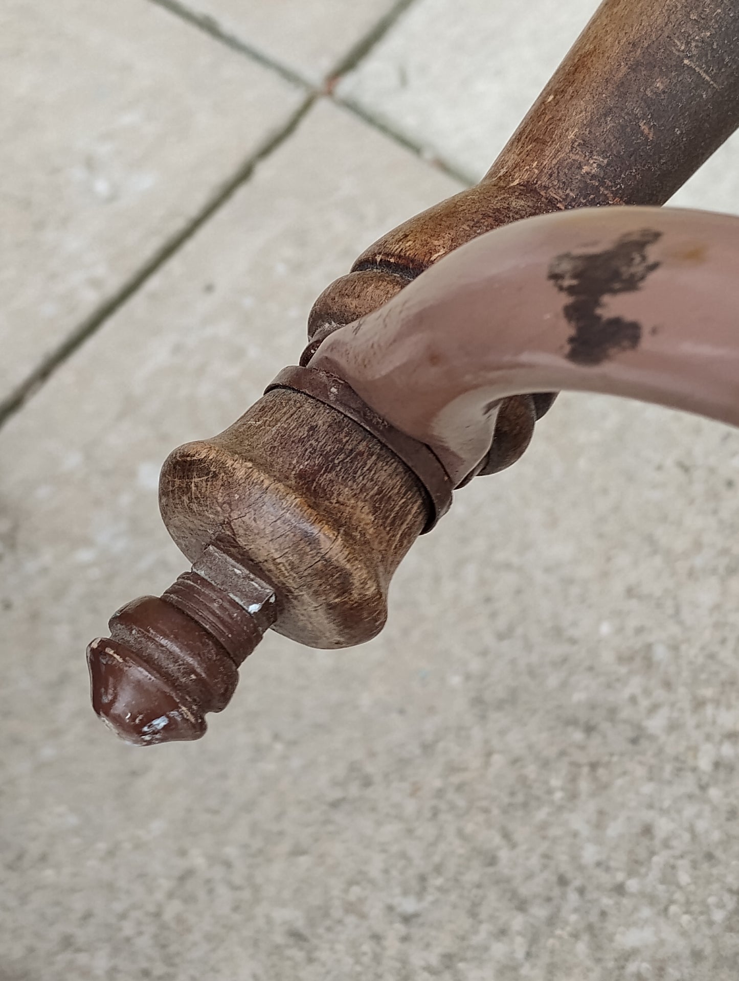 close up of wood handle on antique baby buggy